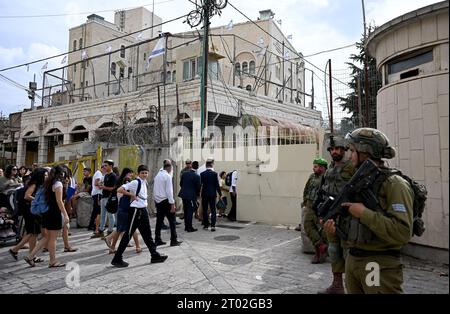 Hebron, Cisgiordania. 3 ottobre 2023. I soldati israeliani proteggono i turisti ebrei che visitano il mercato palestinese durante il festival ebraico di Sukkot, la festa dei Tabernacoli, a Hebron, Cisgiordania, martedì 3 ottobre, 2023. foto di Debbie Hill/ Credit: UPI/Alamy Live News Foto Stock