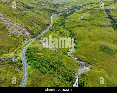Vista aerea della strada panoramica A82 attraverso Glen Coe, con il fiume Coe che scorre giù sulla destra, Highlands, Scozia, Regno Unito Foto Stock