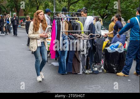 Gli amanti dello shopping cercano occasioni presso il mercatino annuale Penn South Flea Market nel quartiere New York di Chelsea sabato 30 settembre 2023. Il mercato delle pulci appare come Brigadoon, solo una volta all'anno, e i residenti della cooperativa Penn South di 20 edifici hanno uno stravaganza per la pulizia dell'armadio. Gli acquirenti provenienti da tutta la città vengono al mercato delle pulci che attira migliaia di visitatori. (© Richard B. Levine) Foto Stock