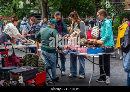 Gli amanti dello shopping cercano occasioni presso il mercatino annuale Penn South Flea Market nel quartiere New York di Chelsea sabato 30 settembre 2023. Il mercato delle pulci appare come Brigadoon, solo una volta all'anno, e i residenti della cooperativa Penn South di 20 edifici hanno uno stravaganza per la pulizia dell'armadio. Gli acquirenti provenienti da tutta la città vengono al mercato delle pulci che attira migliaia di visitatori. (© Richard B. Levine) Foto Stock