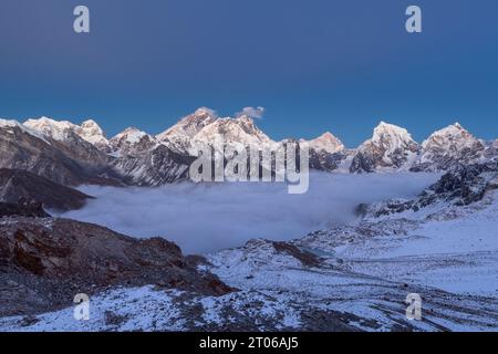 Tramonto sul monte Everest, vista panoramica dal passo Renjo la. Vista mozzafiato della valle di montagna coperta da nubi ricci, Nepal, Himalaya. Foto Stock