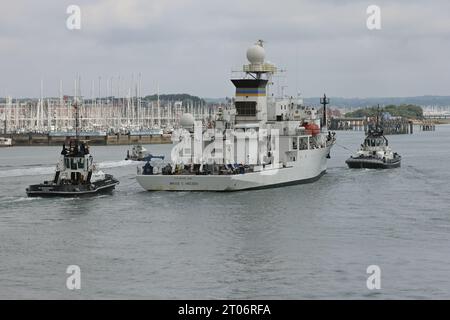 I rimorchiatori del porto scortano la nave della US Navy BRUCE C HEEZEN verso un ormeggio nella base navale Foto Stock