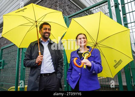 Il leader dell'SNP Humza Yousaf e il candidato dell'SNP Katy Loudon fuori dal seggio elettorale della scuola elementare di St Charles, Cambuslang, durante le elezioni suppletive di Rutherglen e Hamilton West. Data immagine: Giovedì 5 ottobre 2023. Foto Stock