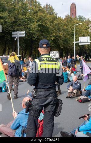 L'Aia, Paesi Bassi - 5 ottobre 2023: I manifestanti di estinzione del clima bloccano il traffico sull'autostrada A12 in procinto di essere arrestati e messi in autobus Foto Stock