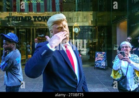 New York, USA. 5 ottobre 2023. Un sosia che indossa una maschera dell'ex presidente degli Stati Uniti Donald Trump si esibisce per i passanti all'ingresso principale della Trump Tower in Fifth Avenue a Midtwown Manhattan. Trump sta attualmente affrontando un processo per frode civile a New York. Crediti: Enrique Shore/Alamy Live News Foto Stock