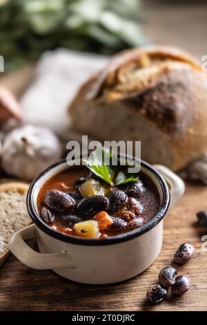 Zuppa tradizionale di fagioli grandi, collo affumicato, patate e carote. Foto Stock