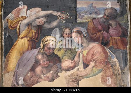 Urbania (Italia, Marche - provincia di Pesaro-Urbino), Oratorio del Corpus Domini, altare sinistro, Raffellino del Colle, affresco con la Sacra famiglia (copia dopo Raffaello) e il padre Eterno (nella lunetta) Foto Stock