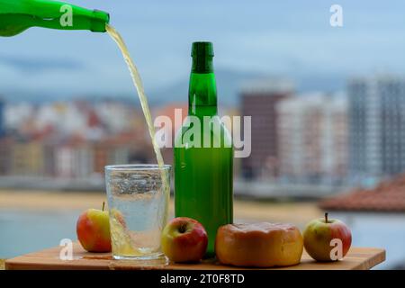 Il sidro asturiano naturale tradizionale fatto da mele fermentate in barile di legno dovrebbe essere versato dalla grande altezza per le bolle d'aria nella bevanda e v Foto Stock