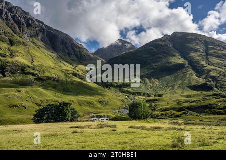 Achnambeithach Cottage sulla riva del Loch Achtriochtan, sopra di esso il Munro Bidean nam Bian, Glencoe, Highlands, Scozia, United, alto 1150 metri Foto Stock