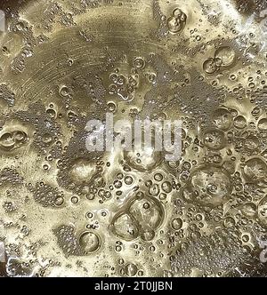 Consistenza di liquido bollente simile all'oro o allo champagne Foto Stock