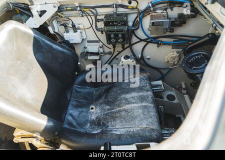 Sedile del pilota all'interno di un carro armato militare. Sedile di guida nero di un pilota di carri armati militare. Luce naturale. Foto di alta qualità Foto Stock