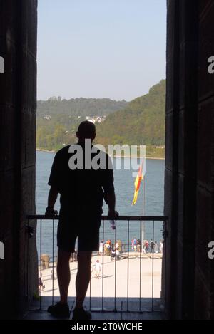 Ein Tourist blickt aus dem begehbaren Kaiser-Wilhelm-Denkmal a Coblenza Rheinland-Pfalz auf das Deutsche Eck und den Rhein. *** Un turista si affaccia sul monumento pedonale Kaiser Wilhelm a Coblenza, Renania-Palatinato, all'angolo tedesco e al fiume Reno Foto Stock