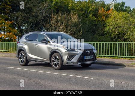 2021 Silver Lexus NX 300H F Sport CVT, Lexus NX 300H F Sport Cvtb300H 197 VVT-i 4WD S/C HEV 155 +143/68hp 105/50kW e-CVT Auto Start/Stop Silver SUV Hybrid Electric 2494 cc che viaggia a velocità sostenuta sull'autostrada M6 a Greater Manchester, Regno Unito Foto Stock