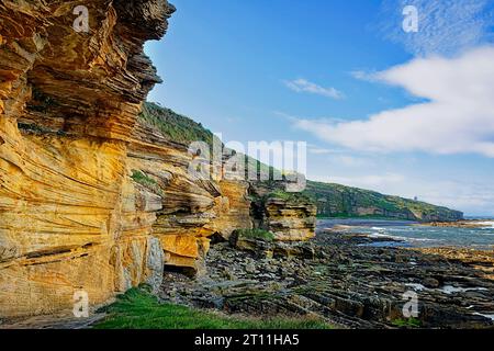 Hopeman Moray Coast Scozia grandi scogliere di arenaria dorata che si affacciano sul mare Foto Stock