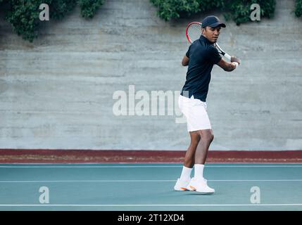L'intera lunghezza di un tennista maschile in piedi su un campo duro durante una partita Foto Stock
