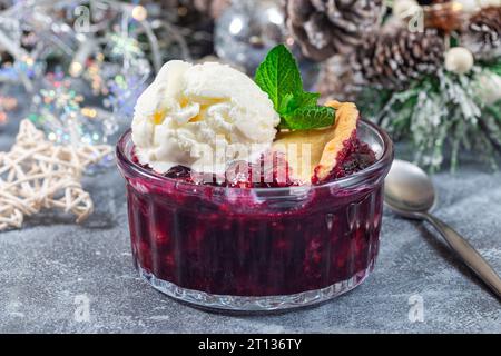 Ciottoli di frutti di bosco in camicia di vetro con gelato, decorazione natalizia su sfondo, orizzontale Foto Stock