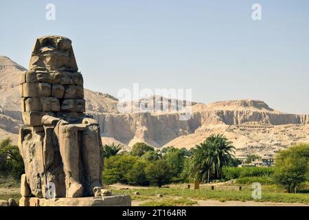 I Colossi di Memnone, una delle due enormi statue in pietra del faraone Amenofi III di fronte al suo tempio funerario, in fase di restauro, Tebe, Foto Stock