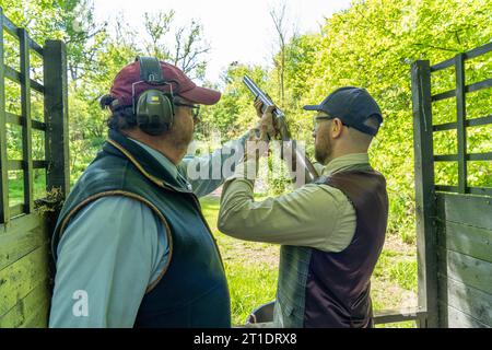 Un uomo che spara piccioni di argilla alla Royal Berkshire Shooting School. Data foto: Mercoledì 24 maggio 2023. Foto: Richard Gray/Alamy Foto Stock