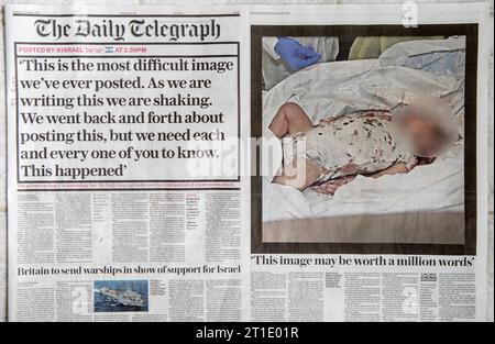 Il quotidiano titola il Daily Telegraph venerdì 13 ottobre 2023, rapporto sull'omicidio di terroristi di Hamas di bambini in un Kibbutz israeliano. 2000 HOMER SYKES Foto Stock