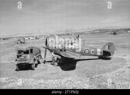 AEREI BRITANNICI IN SERVIZIO NELLA ROYAL AIR FORCE, 1939-1945: HAWKER HURRICANE. (CL 3480) Hurricane Mk.IV, KZ188 'C', del No. 6 Squadron RAF in fase di rifornimento, in mezzo ad altri aeromobili dello Squadron, in dispersione a Prkos, in Jugoslavia. Copyright: © IWM. Fonte originale: http://www.iwm.org.uk/collections/item/object/205211812 Foto Stock