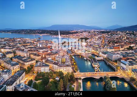 Ginevra, Svizzera, vista dello skyline verso la fontana Jet d'Eau sul Lago di Ginevra al crepuscolo. Foto Stock