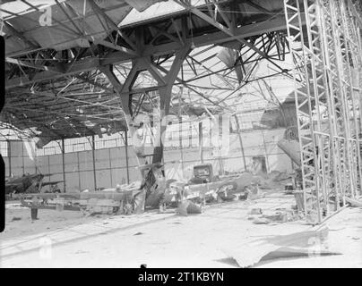 Royal Air Force - Francia, 1939-1940. Interno di un hangar bombardato a Mourmelon-le-Grand dopo un pesante attacco tedesco all'aeroporto il 14 maggio 1940. I resti di un Miles Magister e di almeno due battaglie Fairey, appartenenti al No. 88 Squadron RAF, possono essere visti nel relitto. Les Infrastructures d'Aviation se trouvaient au Camp de Chalons, se situant en partie sur la commune de Mourmelon . Foto Stock