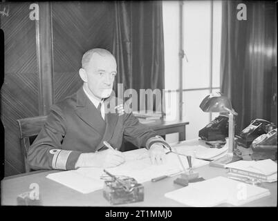 La Royal Navy durante la Seconda Guerra Mondiale l'ammiraglio posteriore D W Boyd, CBE, DSC, la quinta Sea Signore e Capo della Naval Air attrezzature, alla sua scrivania a casa Darland. Foto Stock