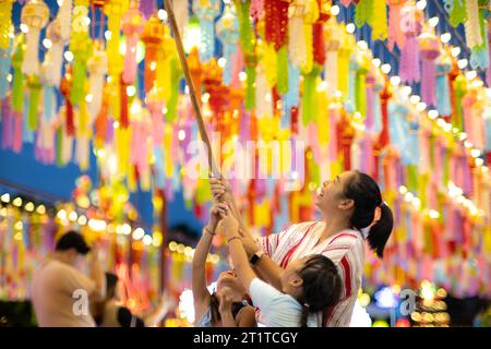 Le famiglie asiatiche fanno desideri e appendono lanterne durante il Festival delle cento mille lanterne o il Festival di Yi Peng nel nord della Thailandia. Foto Stock