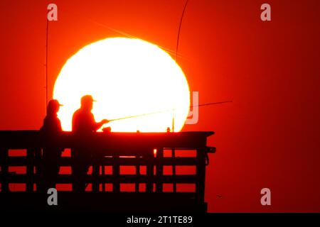 Isola di Palms, Stati Uniti. 15 ottobre 2023. Fisher folk, sagomato dall'alba, è pronto per la mattina a prendere il Sea Cabins Pier in una mattinata fredda nel basso paese, il 15 ottobre 2023 a Isle of Palms, South Carolina. Crediti: Richard Ellis/Richard Ellis/Alamy Live News Foto Stock