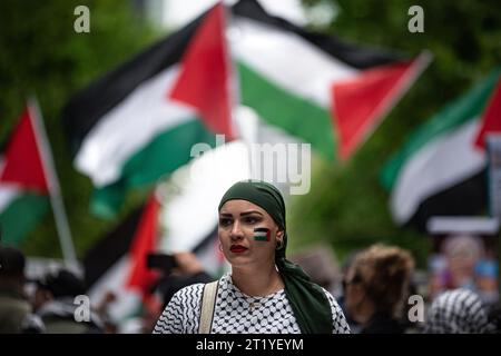 Melbourne, Australia. 15 ottobre 2023, Melbourne, Australia. Una donna con la bandiera palestinese dipinta sul suo volto marcia in un raduno di solidarietà palestinese, a cui hanno partecipato circa 10.000 persone. Crediti: Jay Kogler/Alamy Live News Foto Stock