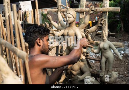 Artigiano impegnato nella preparazione di Durga Idols davanti a Durga Puja in India Foto Stock