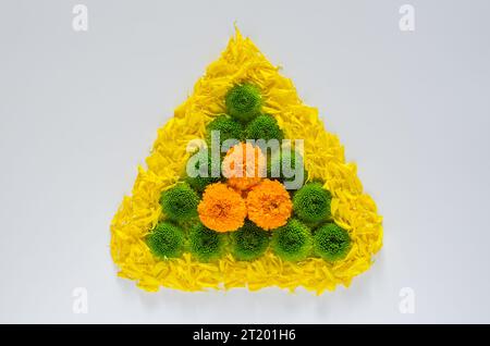 Rangoli decorativi realizzati con fiori di calendula colorati e petali con crisantemo verde per il festival Diwali su sfondo bianco. Foto Stock