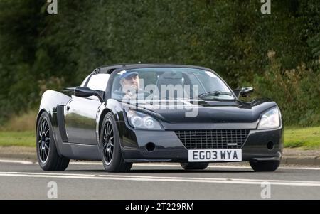 Bicester, Oxon., UK - 8 ottobre 2023: 2003 Vauxhall VX220 auto d'epoca che guida su una strada di campagna inglese. Foto Stock