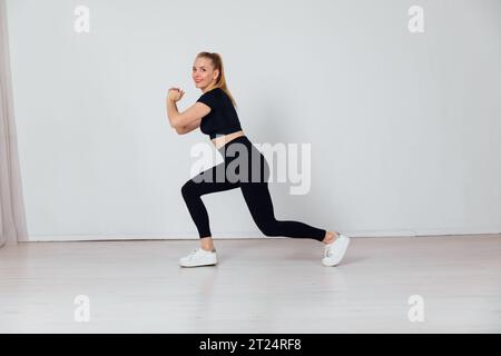 donna impegnata in palestra sportiva con riscaldamento Foto Stock