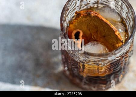 Bevanda al sidro di mele con ghiaccio, fette di mela e bastoncini di cannella Foto Stock