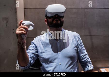 Giovane che gioca con il visore VR all-in-one Meta quest 2 durante ZGamer, un festival di videogiochi, intrattenimento digitale, giochi da tavolo e YouTuber d Foto Stock