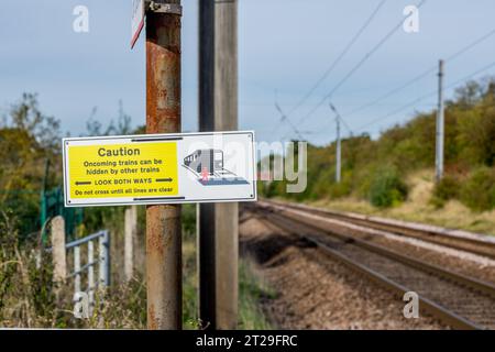 Attenzione, guardare in entrambe le direzioni, segnale di avvertimento al passaggio a livello sulla East Coast Mainline Railway. Foto Stock