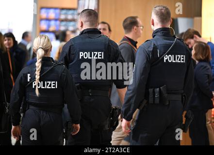 18 ottobre 2023, Assia, Francoforte sul meno: Gli agenti di polizia attraversano il padiglione 3,0 della Fiera del libro di Francoforte. Il paese ospite della più grande mostra di libri del mondo, che si tiene fino al 22 ottobre, è la Slovenia nel suo anniversario. Foto: Arne Dedert/dpa Foto Stock