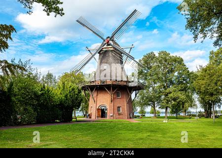 Vecchio mulino a vento nel parco termale con grande albero, Bad Zwischenahn, bassa Sassonia, Germania Foto Stock