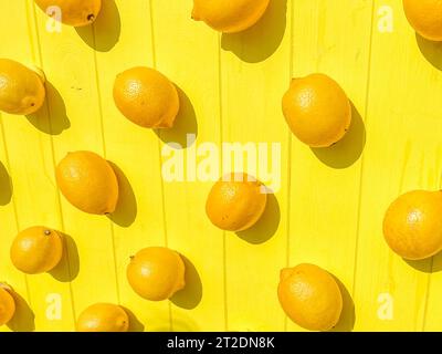 Fette di limoni e arance su una tavola di legno. Immagine ravvicinata della frutta. Foto Stock