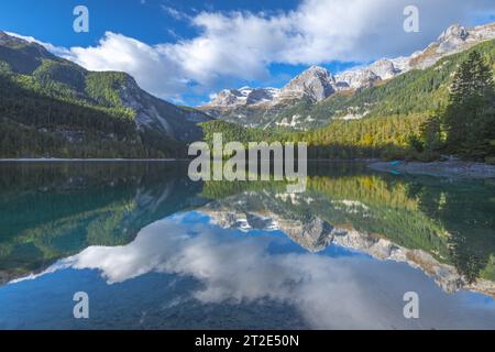 Lago di Tovel nelle Dolomiti di Brenta con perfetti riflessi della catena montuosa. Riflessi montani e vegetazione autunnale. Foto Stock