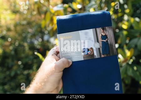 Parigi, Francia - 3 giu 2023: Asciugamano nanufacter di TCHIBO, salvietta blu con TACCO a mano maschile, negozio tedesco con abiti pratici e coifrfe Foto Stock