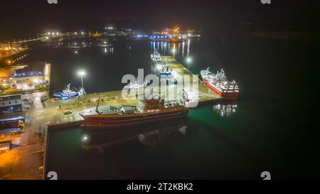 Lerwick, Shetland, Scozia, poi in drone di notte mostrando città, porto e flotta pelagica dall'alto al Mair's Pier. Foto Stock