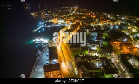 Lerwick, Shetland, Scozia, poi in drone di notte mostrando città, porto e flotta pelagica dall'alto al Mair's Pier. Foto Stock