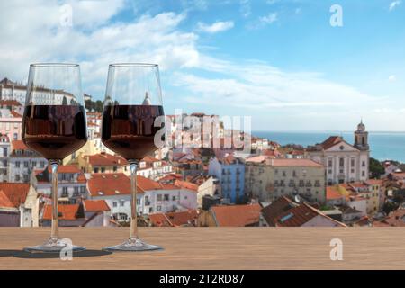 Due bicchieri di vino rosso in vista della città vecchia di Lisbona nel quartiere Alfama di Lisbona, Portogallo Foto Stock