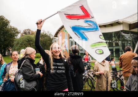 Cambridge, Regno Unito. 21 ottobre 2023. I residenti locali prendono parte a una danza a tema anni '1970 e marciano lungo Mill Road per chiedere l'introduzione di un cancello degli autobus per limitare i flussi di traffico nella strada della città. MillRoad4people sostiene che il 72% dei locali ha votato a favore del programma che ridurrebbe il flusso di veicoli sulla strada, ma non è stata ancora intrapresa alcuna azione per attuare i cambiamenti. Mill Road, che è composta da molti negozi indipendenti, aziende e aree residenziali, soffre di congestione del traffico. Crediti: Julian Eales/Alamy Live News Foto Stock