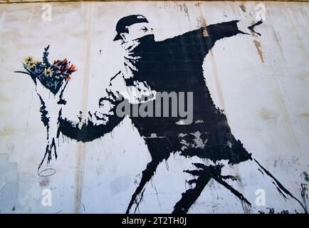 Il famoso murale di Banksy "Rage, the Flower Thrower (Love is in the Air)", dipinto su un autolavaggio in un sobborgo di Betlemme (Palestina) Foto Stock