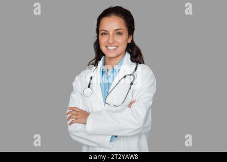 Medico sorridente con stetoscopio, braccia incrociate Foto Stock
