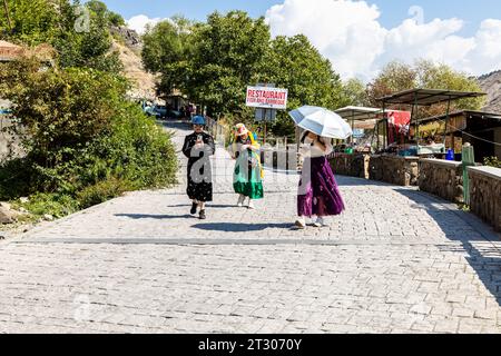 Garni, Armenia - 30 settembre 2023: I turisti si recano alla sinfonia del luogo delle pietre nella gola di Garni in Armenia in una soleggiata giornata autunnale Foto Stock