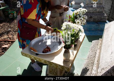 I thailandesi rispettano il rito rituale del merito offrendo sacrificio di cibo all'antenato presso l'urna del cimitero nel festival del decimo mese lunare o Sat Duan SIP at Foto Stock